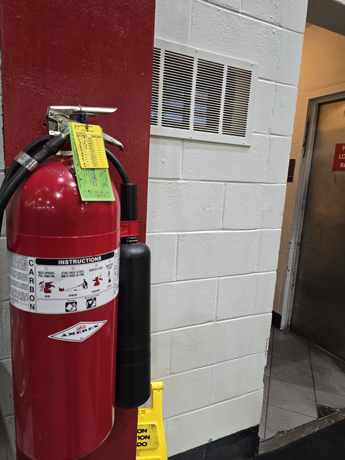 Carbon dioxide fire extinguisher mounted in a commercial corridor